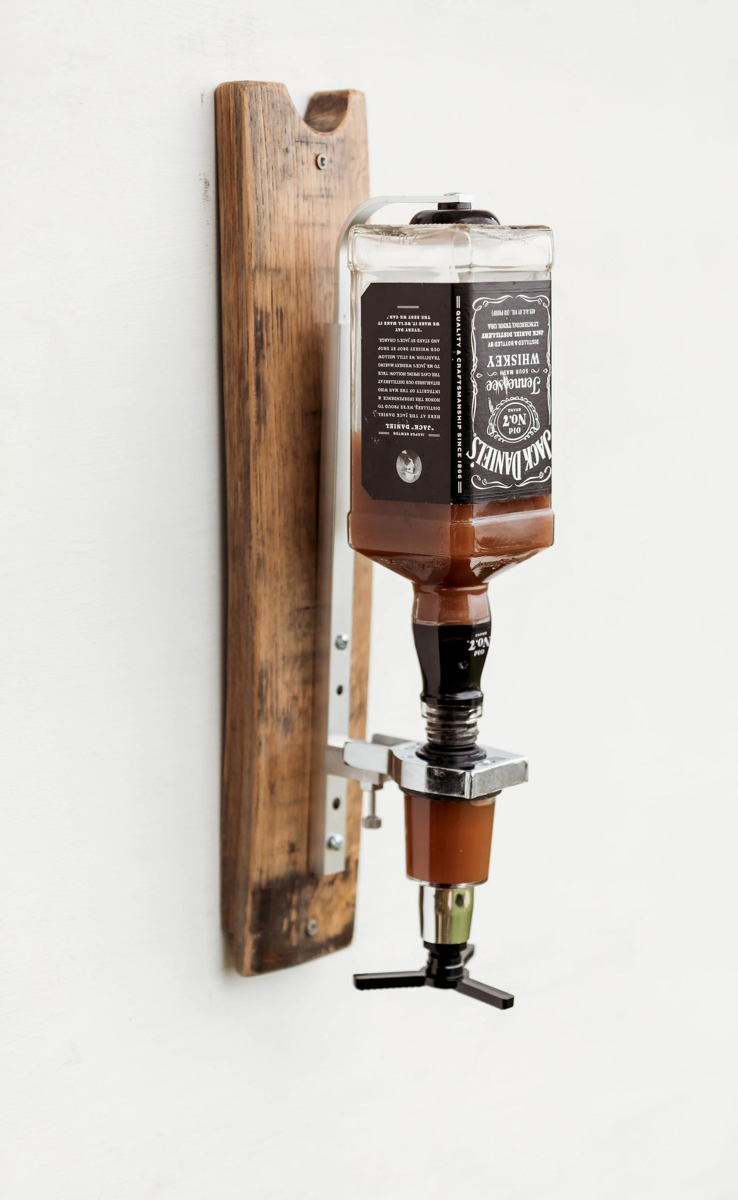 Angled view of single pour whiskey dispenser in walnut finish.