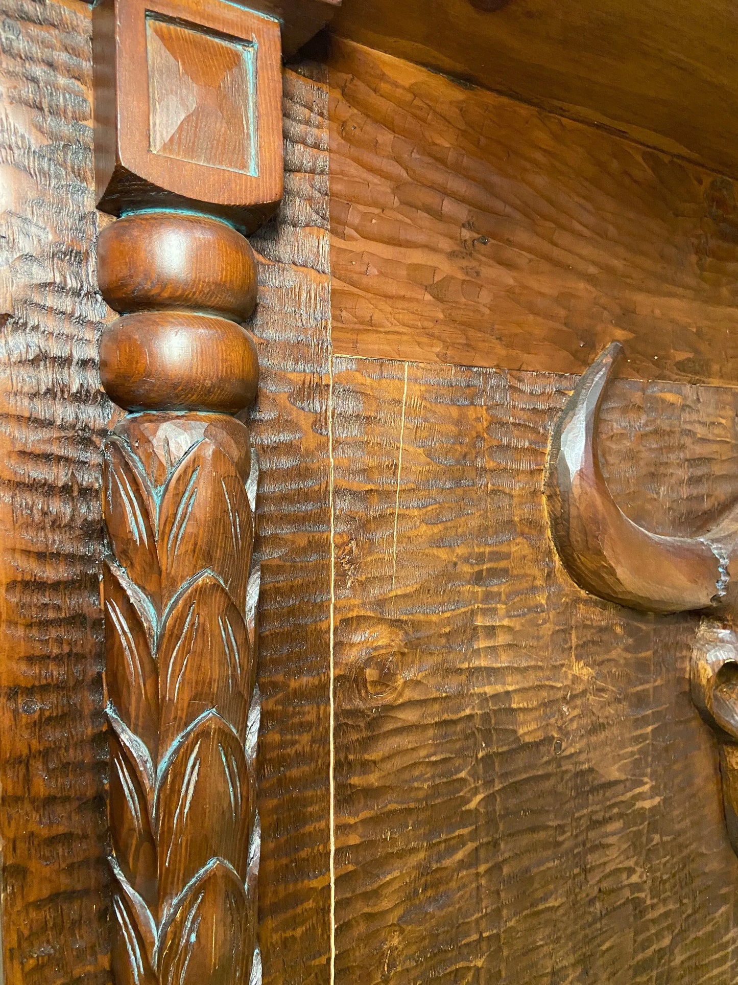 Close up of left front side of bar and detailed hand carved spindles