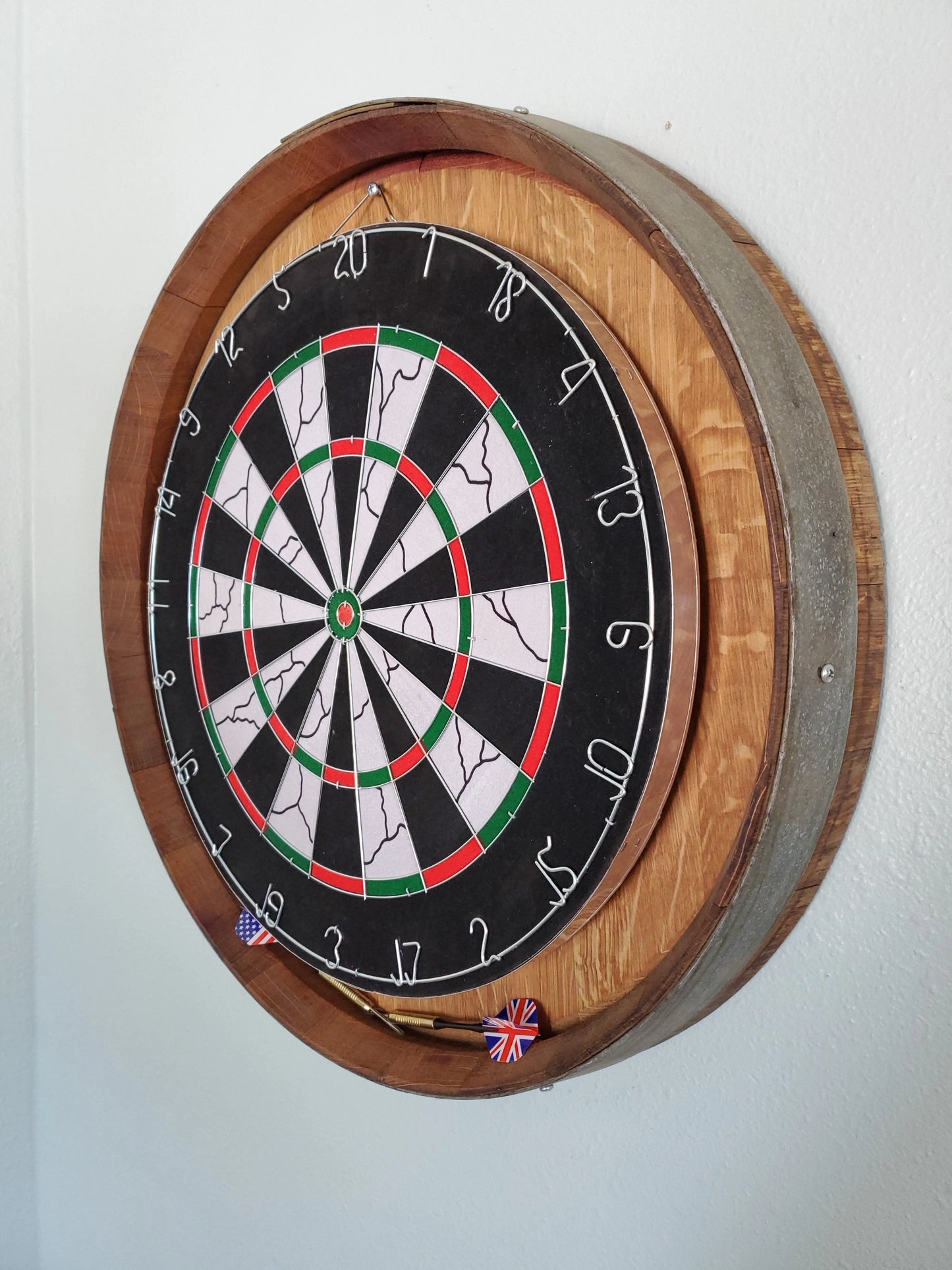 Side view of the Barrel Head Dartboard, complete with dartboard and six weighted darts