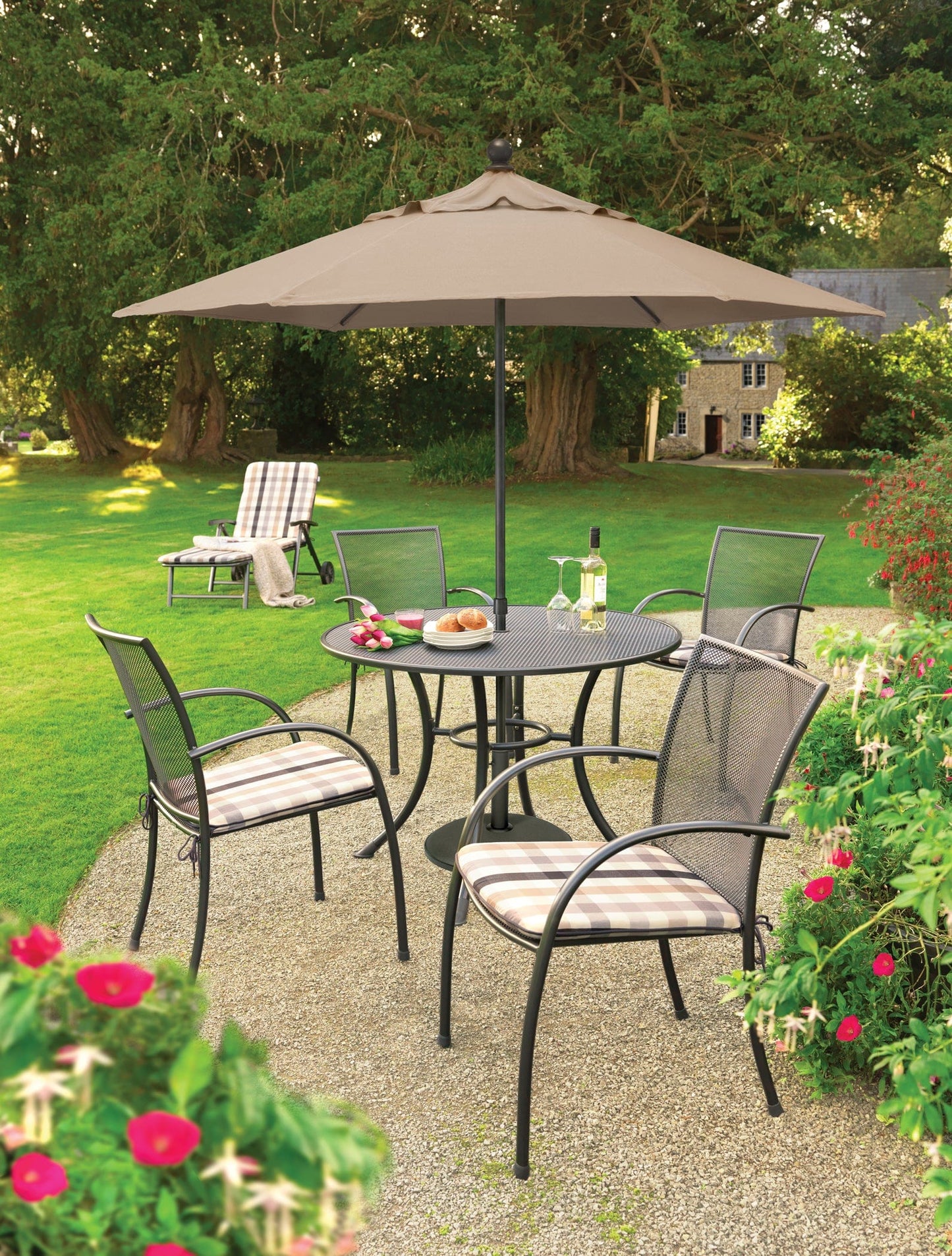 KETTLER® Pilano Iron Mesh set shown here with umbrella and chaise lounge