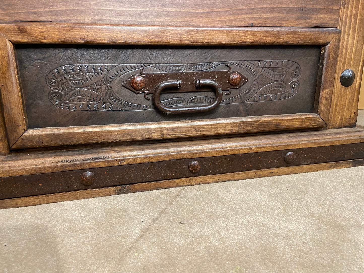 front of drawer showing hand forged steel handle & hand tooled leather