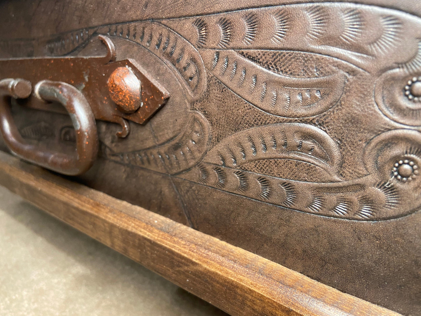 Close up of hand tooled leather on drawer.